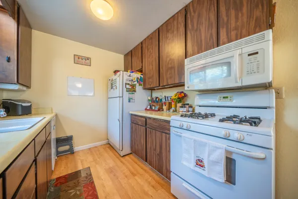 a kitchen with sink cabinets and stove top oven
