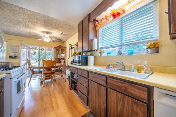 a open kitchen with sink and cabinets