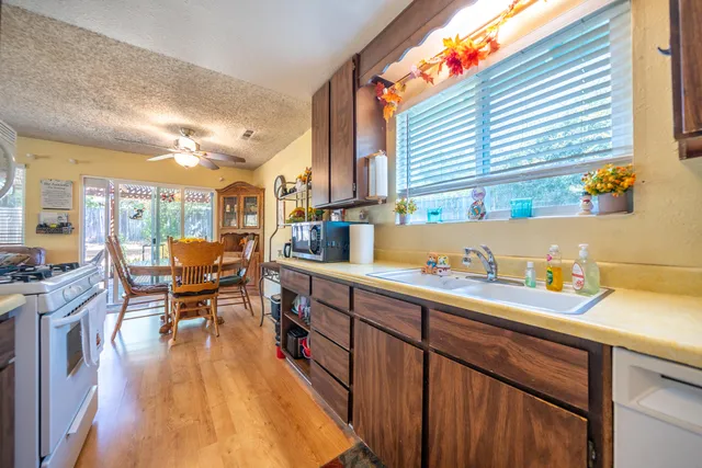 a open kitchen with sink and cabinets