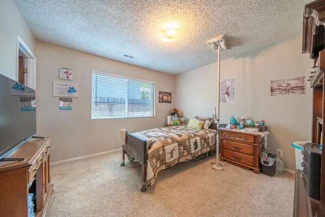 a bedroom with bed and a window