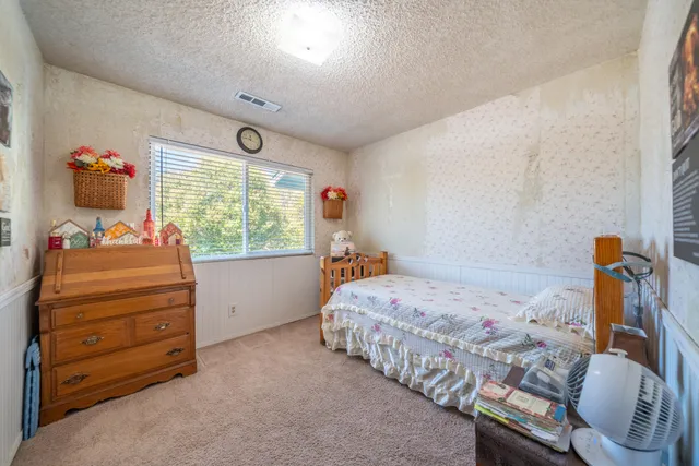 a bedroom with a bed and a window