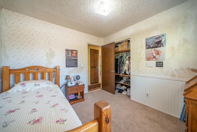 a bedroom with furniture and a wooden floor