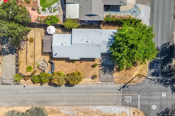 an aerial view of a house with a yard and a garage