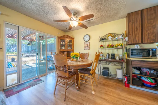 a view of a dining room with furniture a chandelier and wooden floor