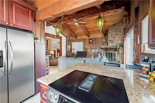 a kitchen with stainless steel appliances granite countertop a refrigerator a stove and a sink with granite countertops