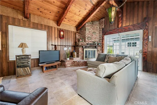 a living room with furniture a fireplace and a counter top space