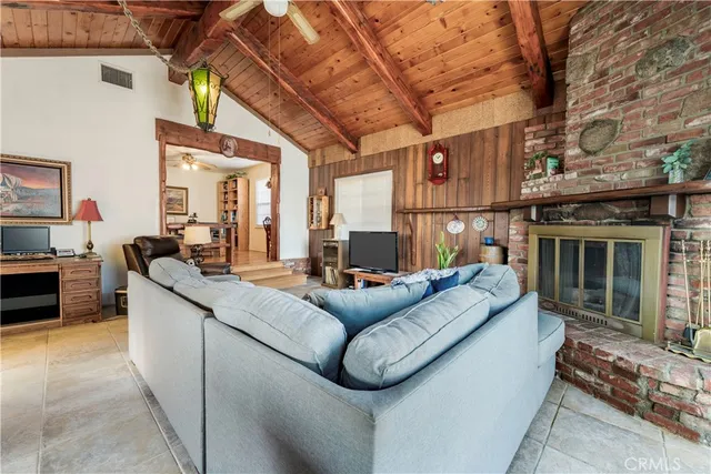 a living room with furniture a fireplace and a table