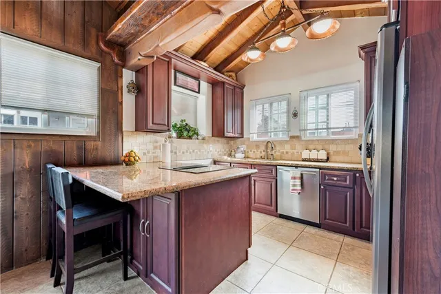 a kitchen with a sink a counter space and appliances
