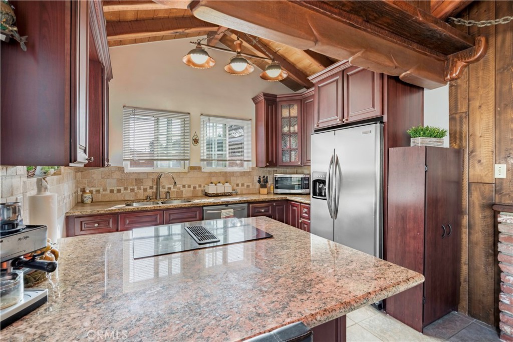 5016 Falcon Avenue Long Beach, CA 90807 - Photo 10 of 23 a kitchen with stainless steel appliances granite countertop a sink a refrigerator and a stove