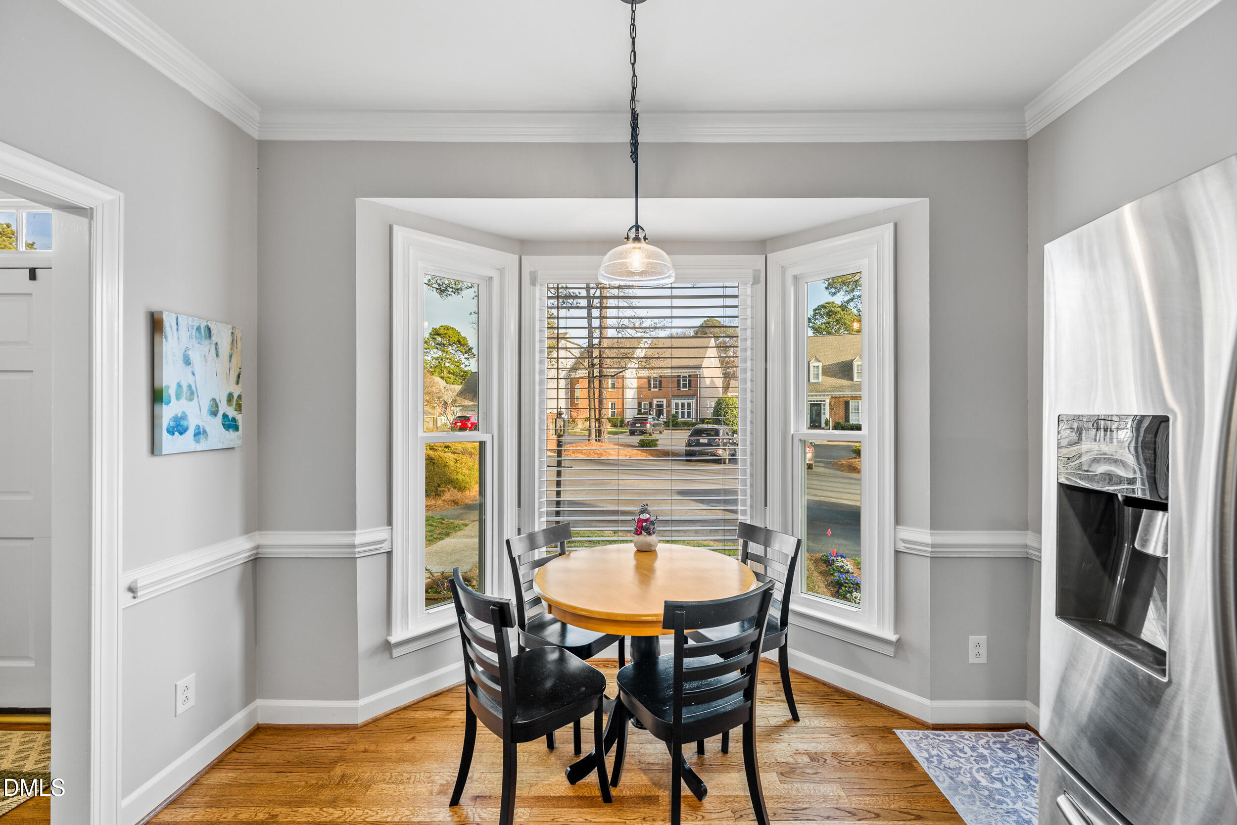 6011 Tenter Banks Square Raleigh, NC 27609 - Photo 11 of 37 a dining room with furniture a chandelier and wooden floor