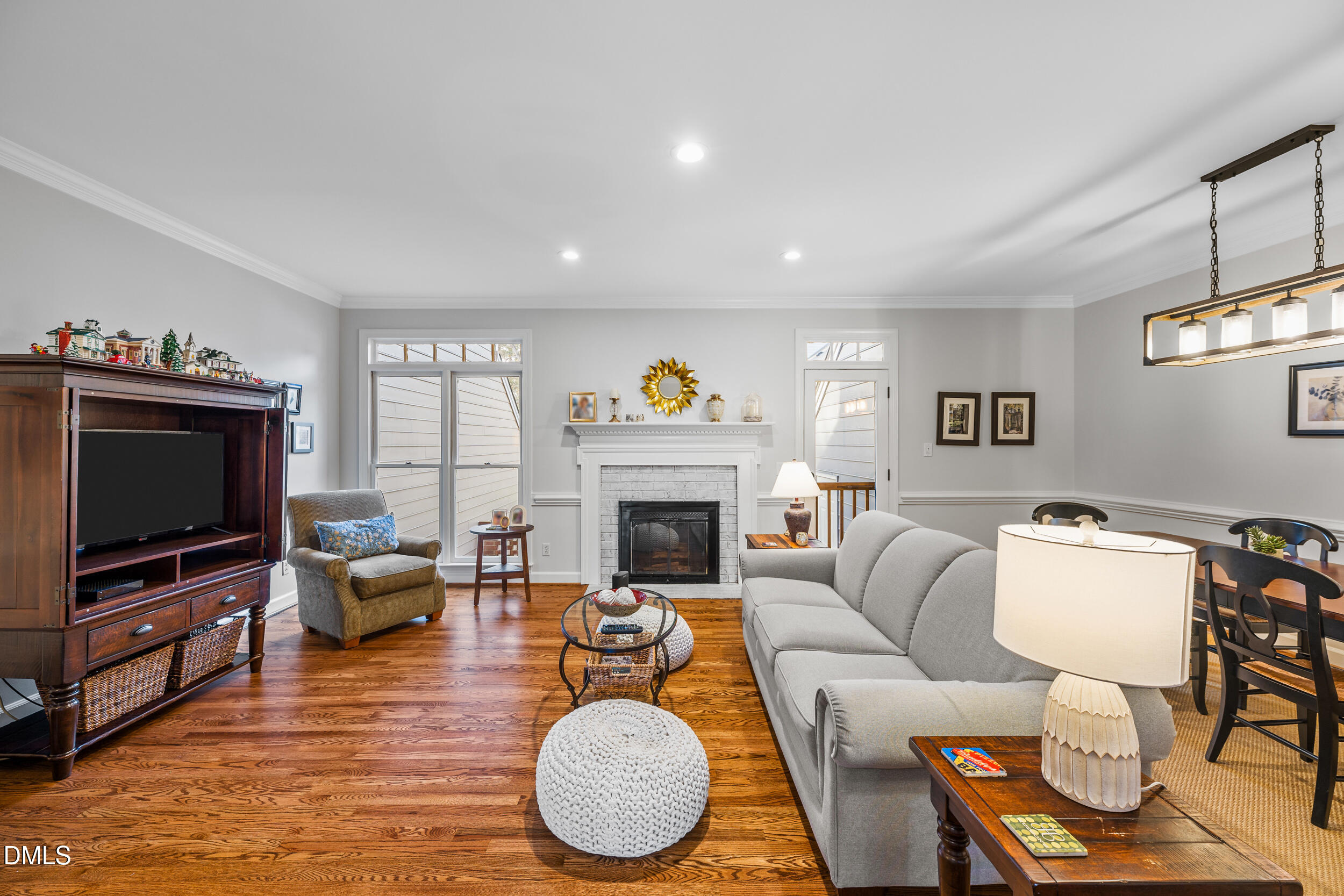 6011 Tenter Banks Square Raleigh, NC 27609 - Photo 13 of 37 a living room with furniture a fireplace and a flat screen tv