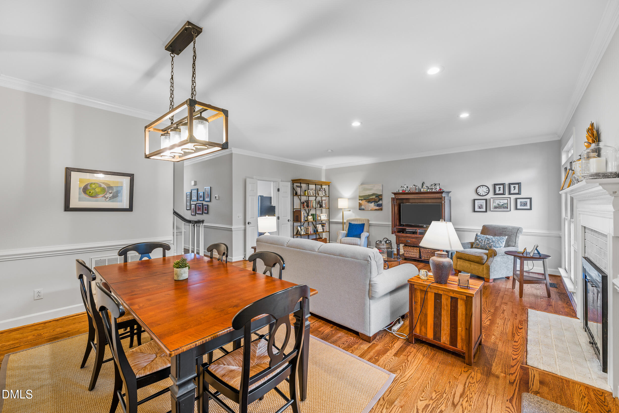 6011 Tenter Banks Square Raleigh, NC 27609 - Photo 15 of 37 a view of a dining room with furniture a chandelier and wooden floor