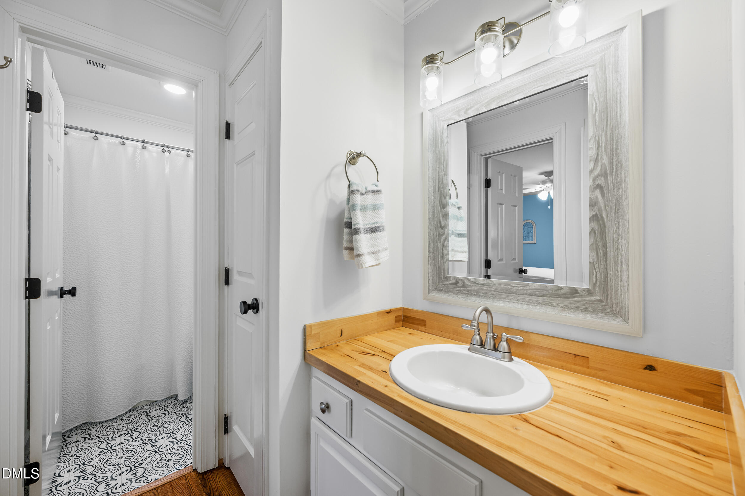 6011 Tenter Banks Square Raleigh, NC 27609 - Photo 21 of 37 a bathroom with a granite countertop sink and a mirror
