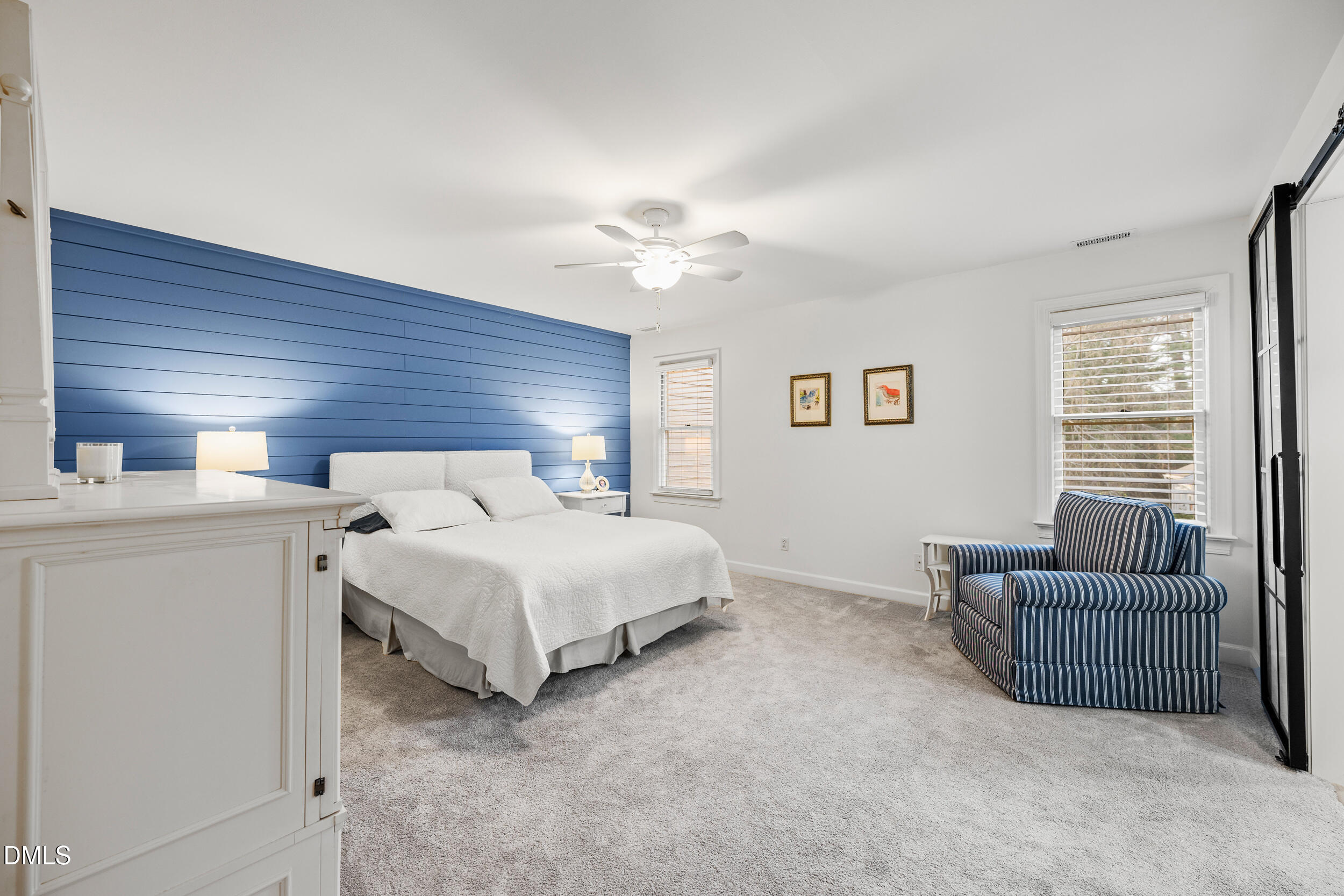 6011 Tenter Banks Square Raleigh, NC 27609 - Photo 22 of 37 a spacious bedroom with a bed and a chandelier