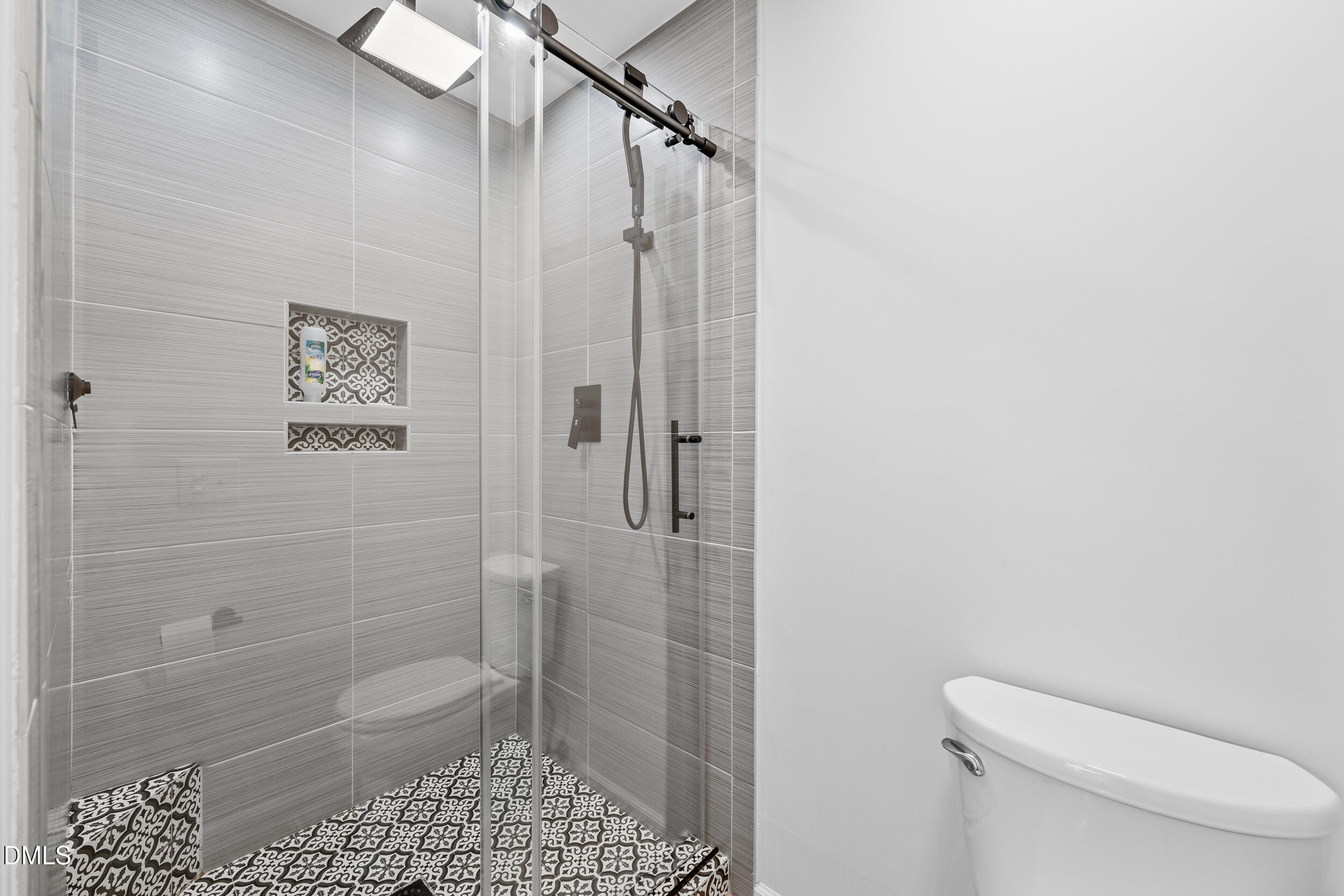 6011 Tenter Banks Square Raleigh, NC 27609 - Photo 27 of 37 a bathroom with a shower a toilet and a sink