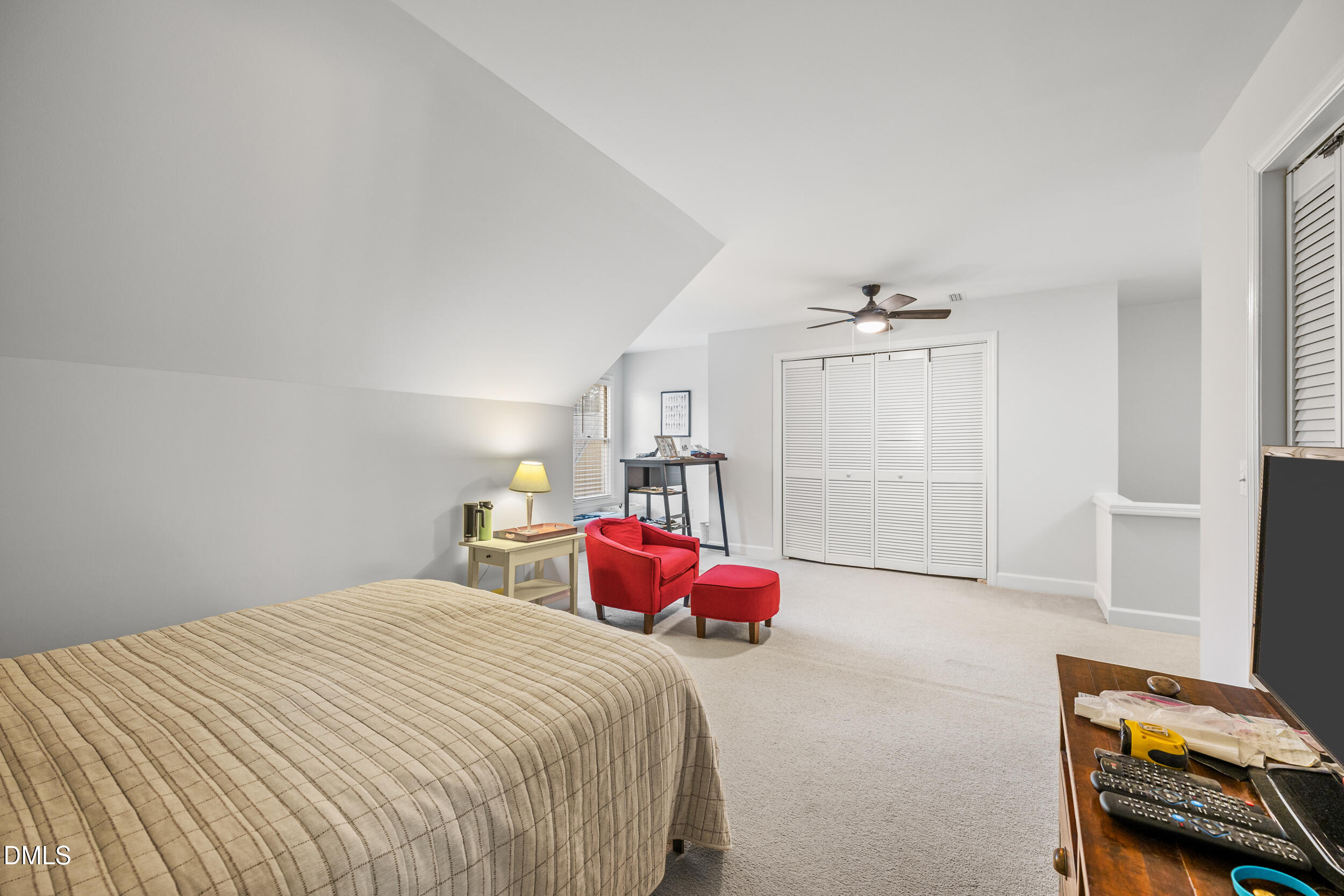 6011 Tenter Banks Square Raleigh, NC 27609 - Photo 31 of 37 a bedroom with a bed and a chair