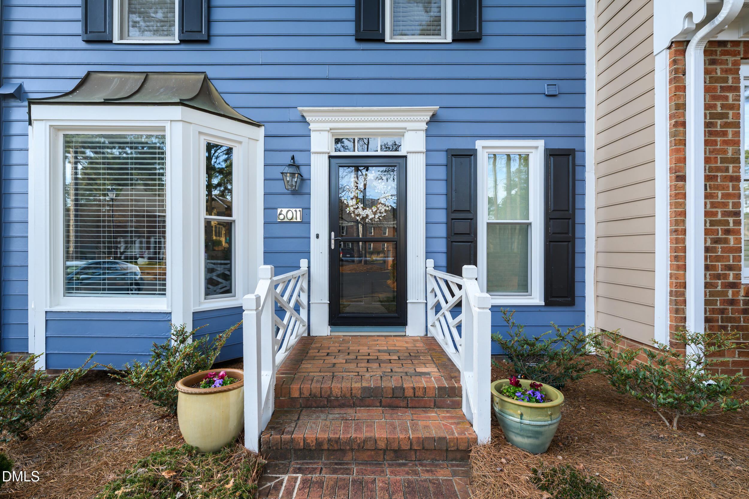 6011 Tenter Banks Square Raleigh, NC 27609 - Photo 4 of 37 a front view of a house with a chairs and potted plants