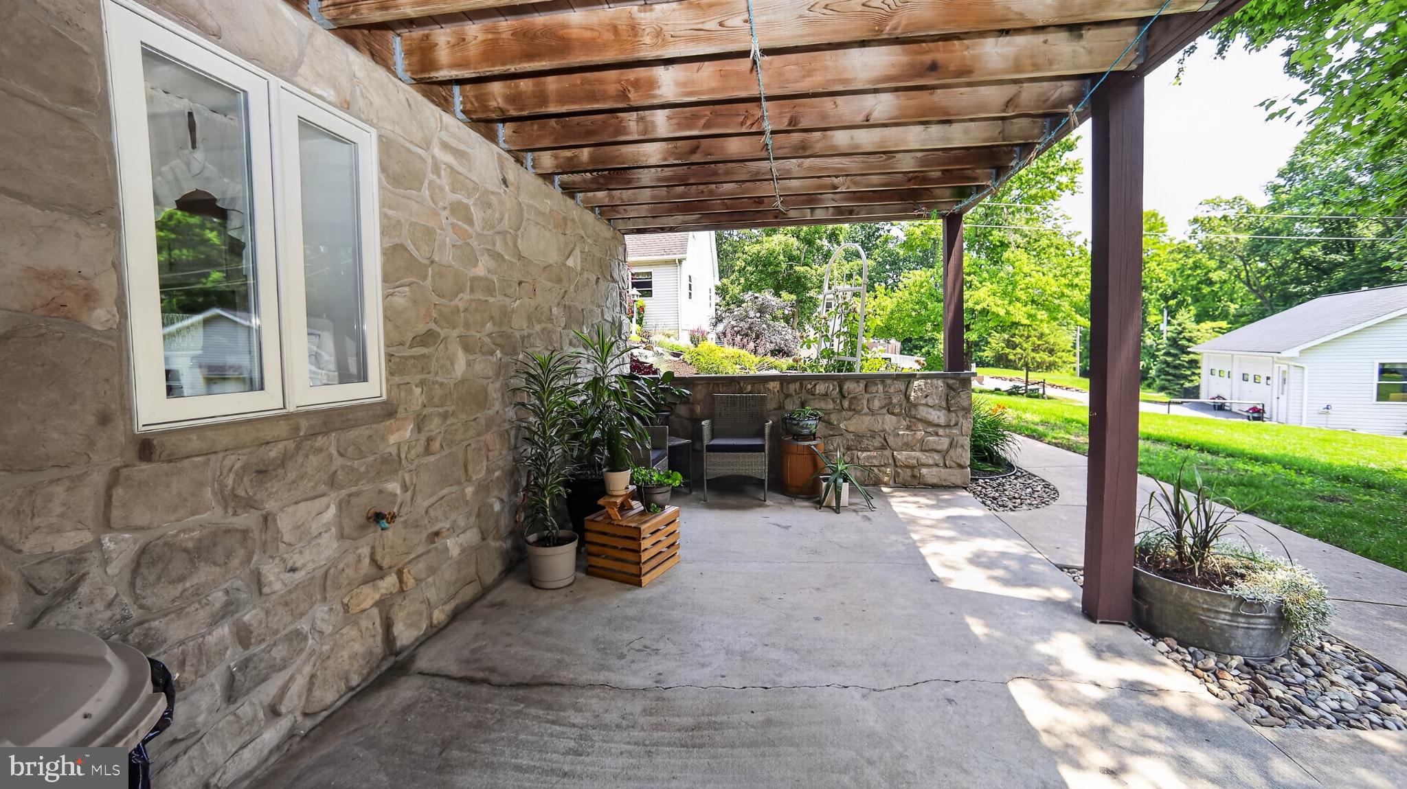 257 Hill Road New Holland, PA 17557 - Photo 82 of 94 Charming stone patio with greenery.