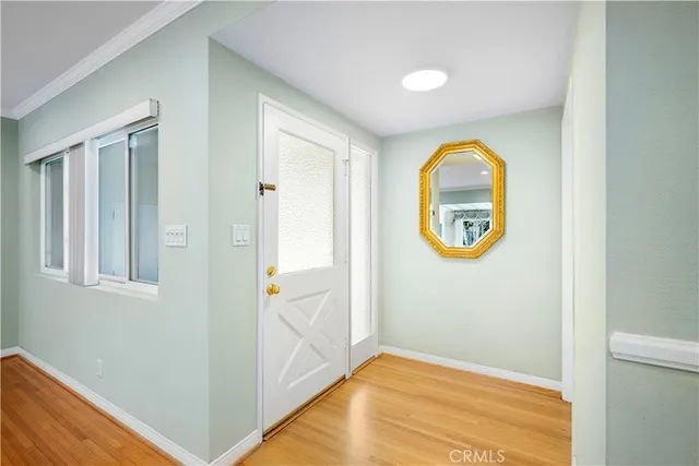 an empty room with window and wooden floor