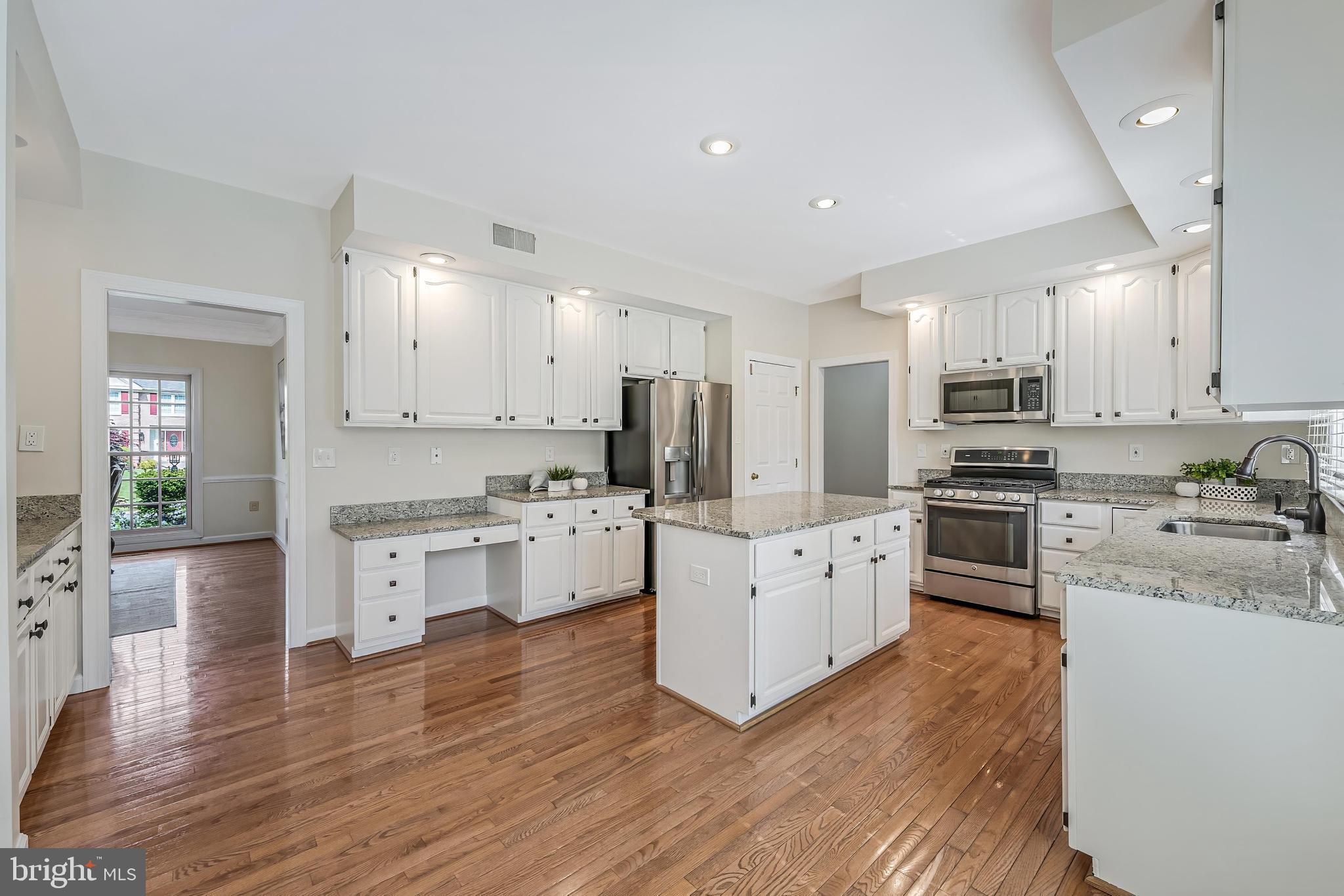 5501 Ashleigh Road Fairfax, VA 22030 - Photo 31 of 77 a kitchen with granite countertop white cabinets and stainless steel appliances