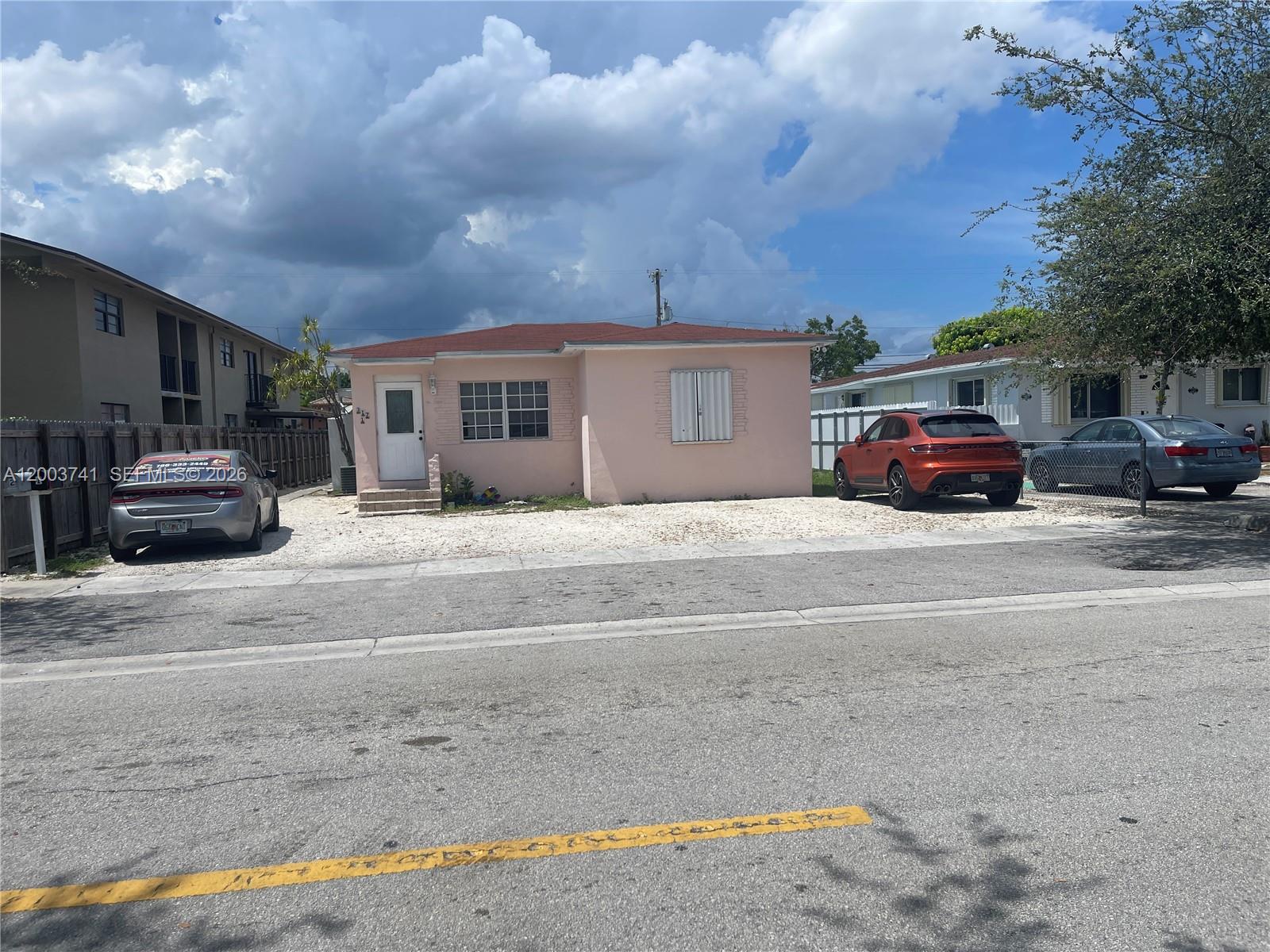 317 East 8th Street, Unit 3 Hialeah, FL 33010 - Photo 1 of 19 a view of a car park in front of house
