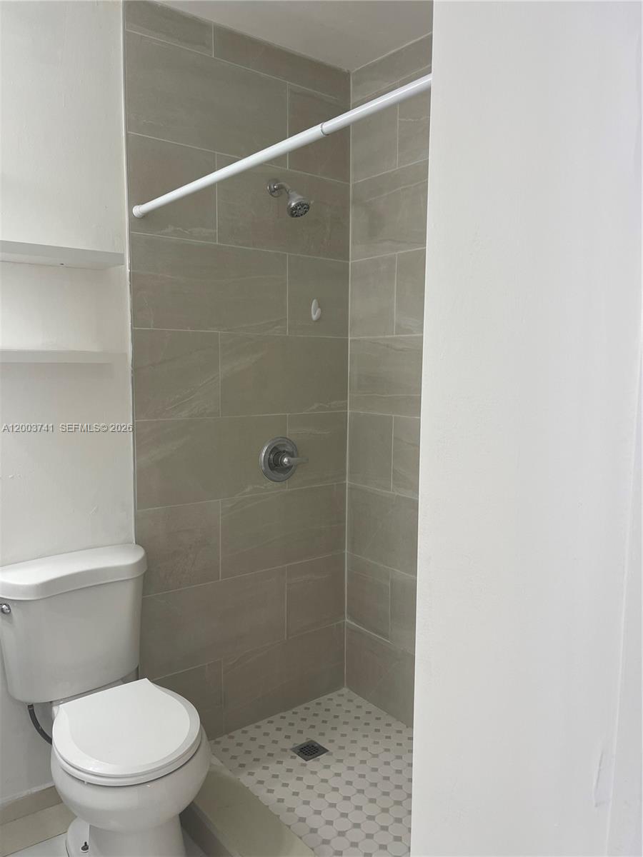 317 East 8th Street, Unit 3 Hialeah, FL 33010 - Photo 14 of 19 a white toilet sitting next to a shower