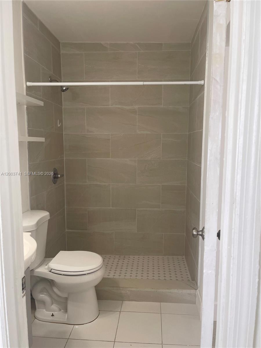 317 East 8th Street, Unit 3 Hialeah, FL 33010 - Photo 15 of 19 a bathroom with a toilet and a shower