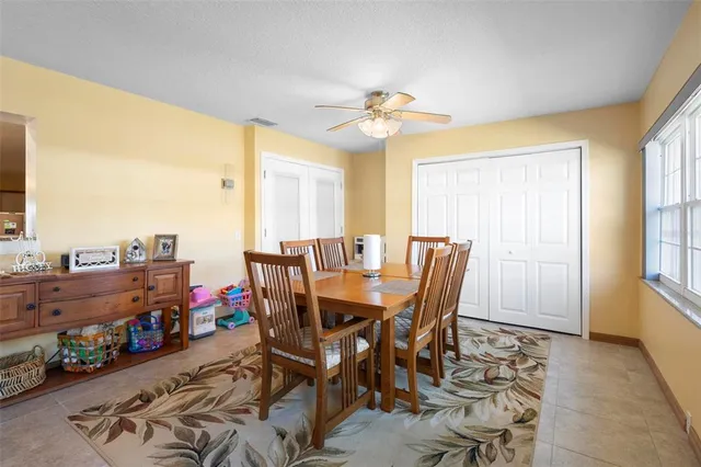 a view of a dining room with furniture and a chandelier