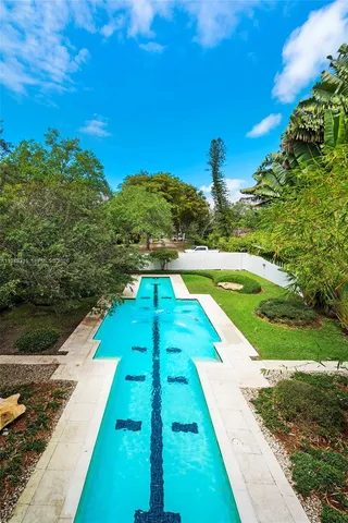 a view of a swimming pool with a yard