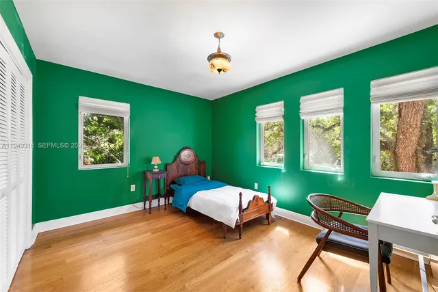 a bedroom with bed and window