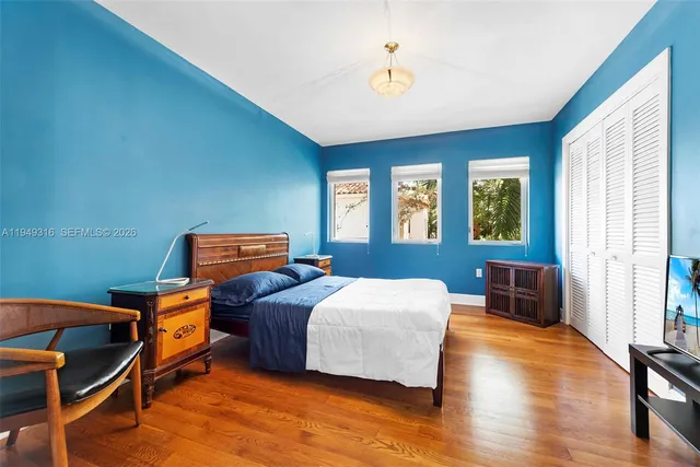 a view of a house with a big yard and large trees