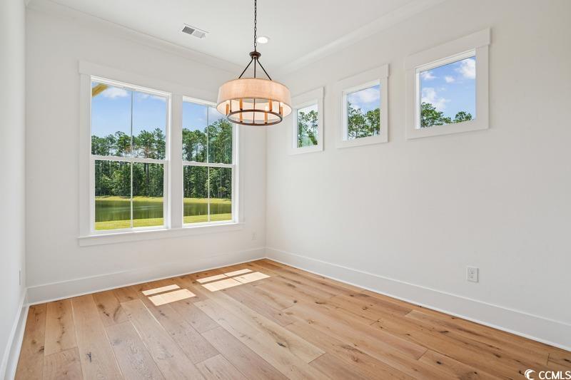 6709 Genesis Drive Murrells Inlet, SC 29576 - Photo 6 of 14 Unfurnished room with a chandelier, light wood fin