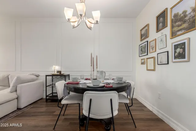 a kitchen with stainless steel appliances kitchen island granite countertop a refrigerator a stove and a wooden floors