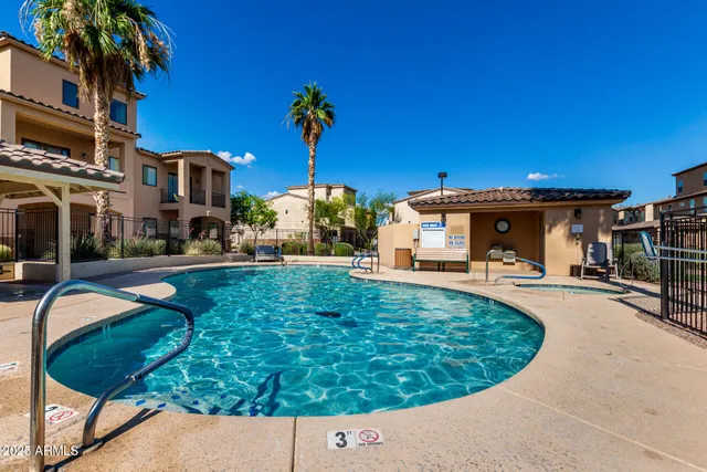 a view of a house with swimming pool and sitting area