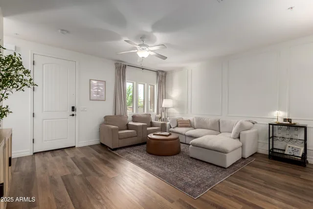 a living room with furniture and wooden floor