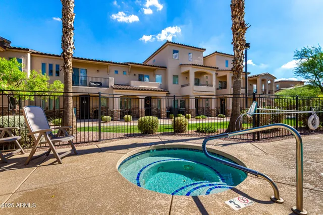 a front view of a house with swimming pool table and chairs