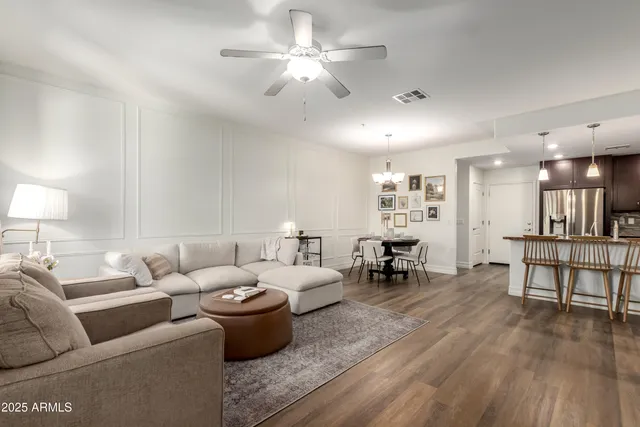 a living room with furniture and a wooden floor