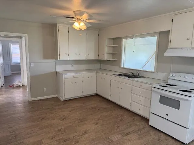 a kitchen with granite countertop white cabinets white stainless steel appliances with a sink and dishwasher
