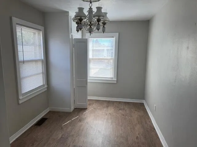 an empty room with windows and closet