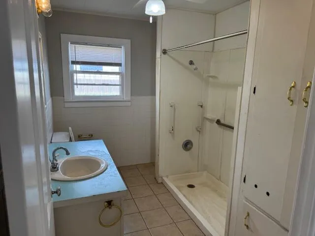 a bathroom with a sink a mirror and a shower