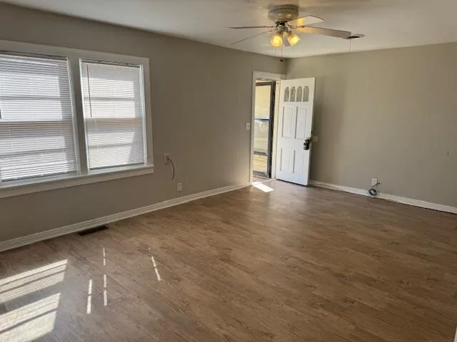 wooden floor in an empty room with a window