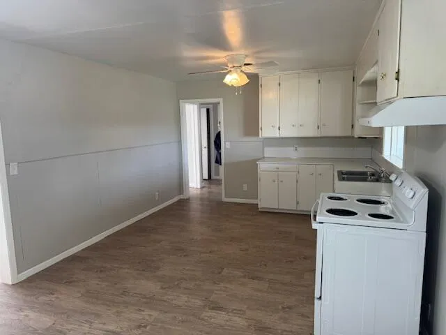 a kitchen with a stove cabinets and a refrigerator