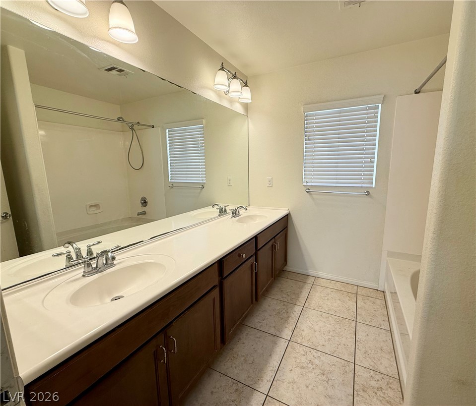 6459 Parrot Ridge Court Las Vegas, NV 89139 - Photo 17 of 23 Upstairs hall bath. Double vanity sinks and bright lighting enhance this well-appointed bathroom space.