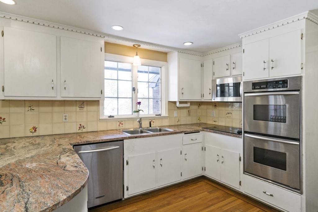 62 Rust Way Cohasset, MA 02025 - Photo 5 of 17 a kitchen with a sink stove and cabinets