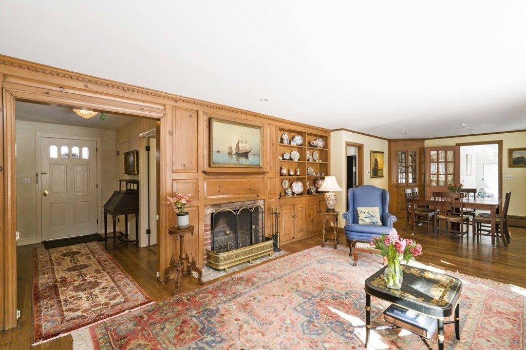 62 Rust Way Cohasset, MA 02025 - Photo 6 of 17 a living room with furniture a dining table and a fireplace