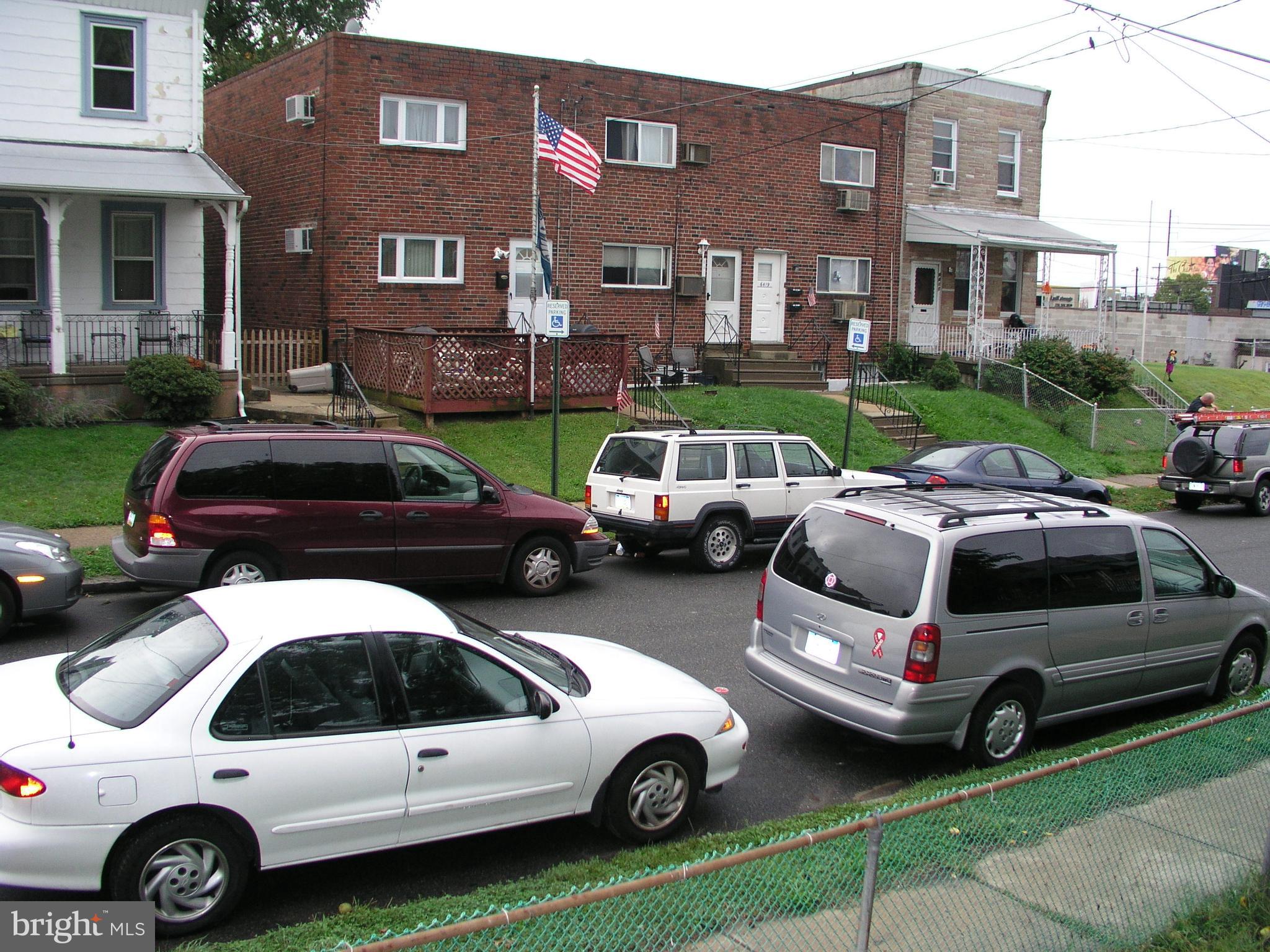 6422 Tulip Street Philadelphia, PA 19135 - Photo 3 of 4 a view of a cars parked in front of a brick house