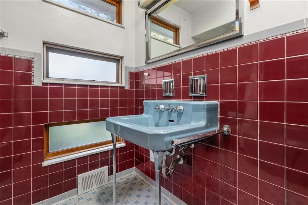 357 Churchill Road Pittsburgh, PA 15235 - Photo 18 of 28 a bathroom with a sink toilet shower and a mirror