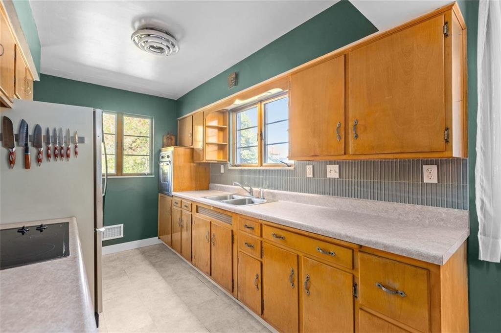 357 Churchill Road Pittsburgh, PA 15235 - Photo 8 of 28 a kitchen with stainless steel appliances granite countertop a sink a stove and a refrigerator