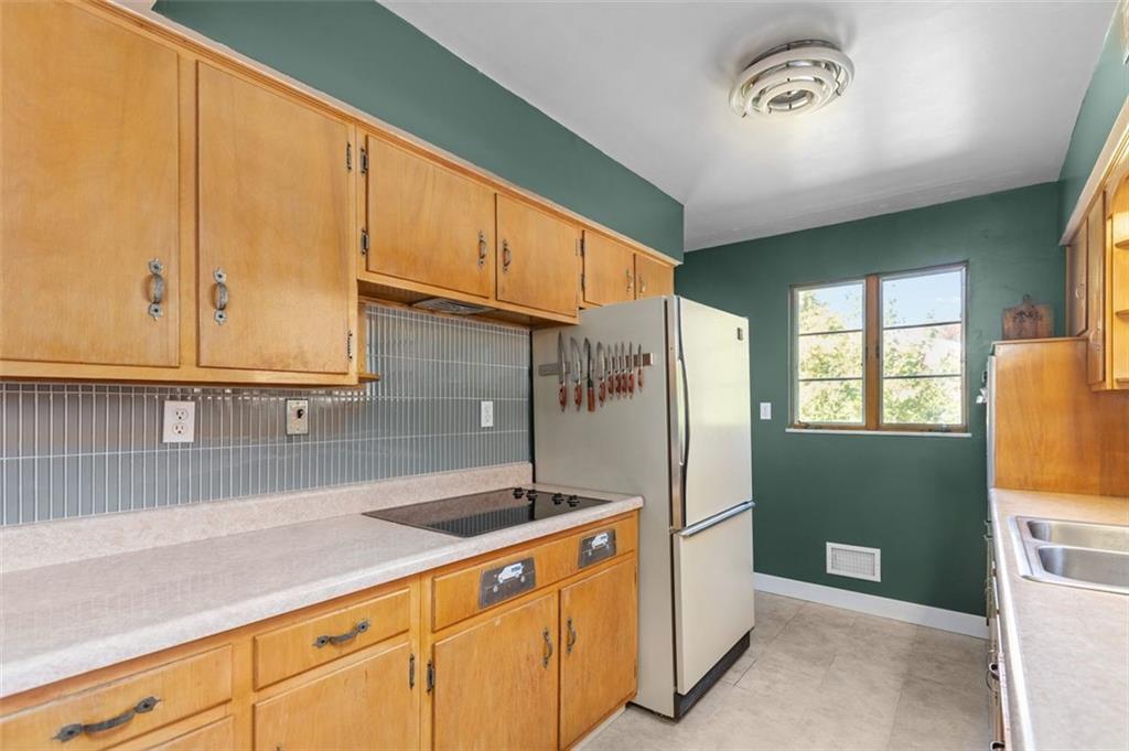357 Churchill Road Pittsburgh, PA 15235 - Photo 9 of 28 a kitchen with stainless steel appliances granite countertop a refrigerator a sink and dishwasher with wooden cabinets