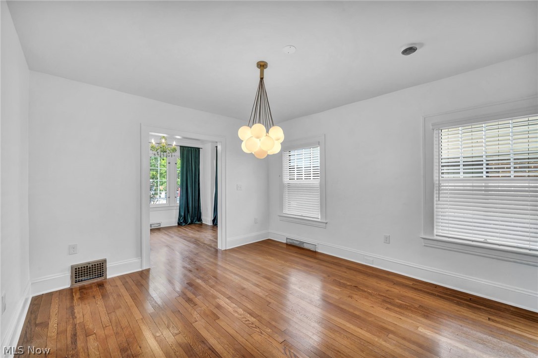 2135 Coventry Road, Unit DOWN Cleveland, OH 44118 - Photo 10 of 34 Unfurnished dining area featuring light wood finished floors, healthy amount of natural light, and suspended lighting